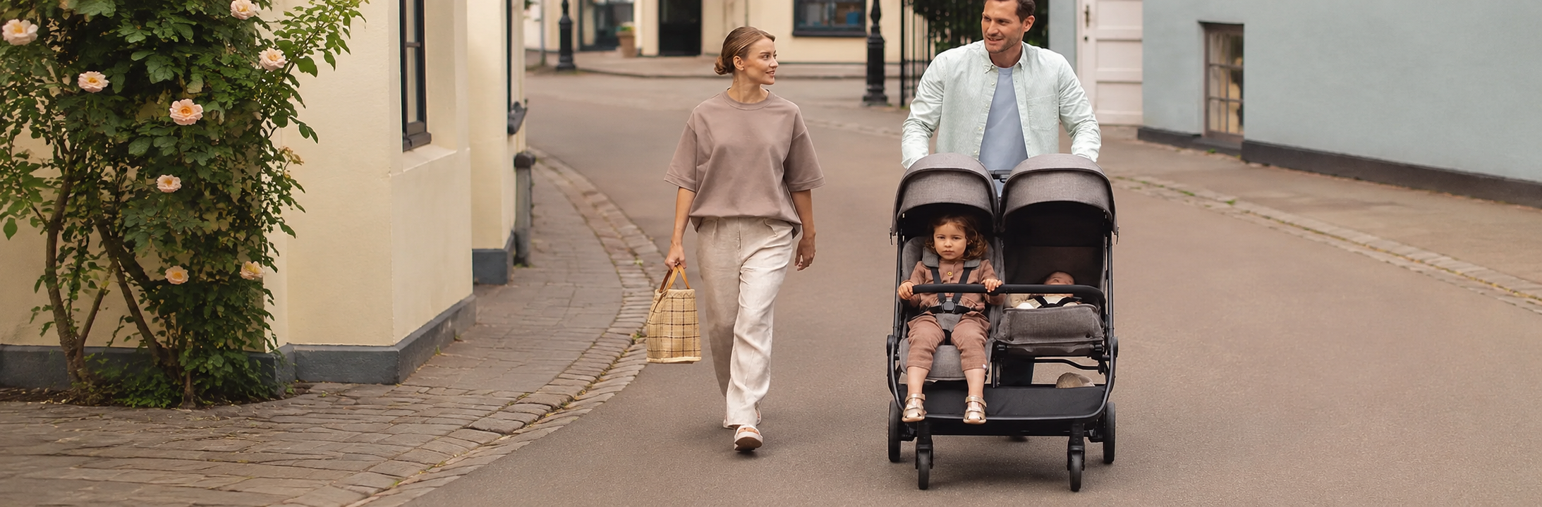 nuna strollers canada couple walking a stroller of 2 kids 