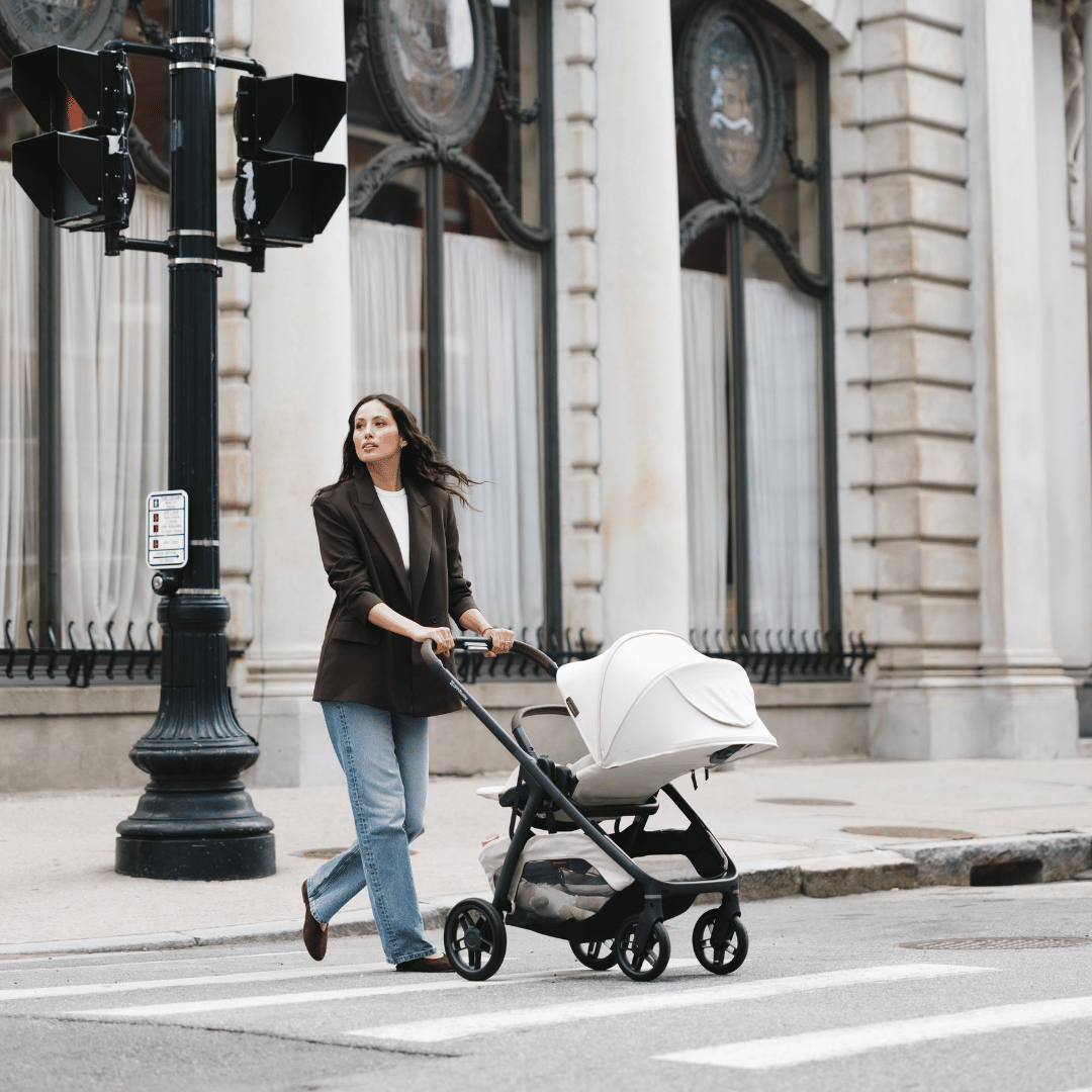 white kona stroller ada model on sidewalk